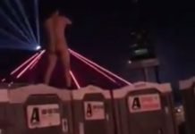 naked dude jumps off festival toilets