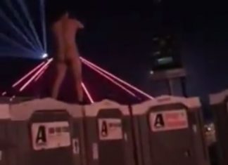 naked dude jumps off festival toilets